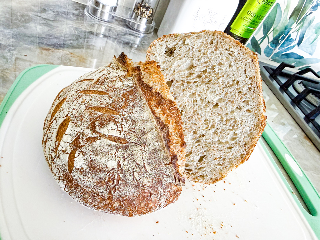 A sliced sourdough loaf showing an even, airy crumb