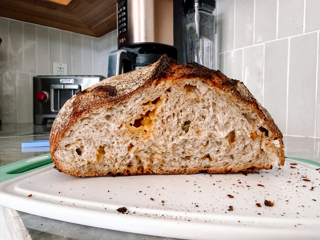 A sliced jalapeño cheddar sourdough loaf